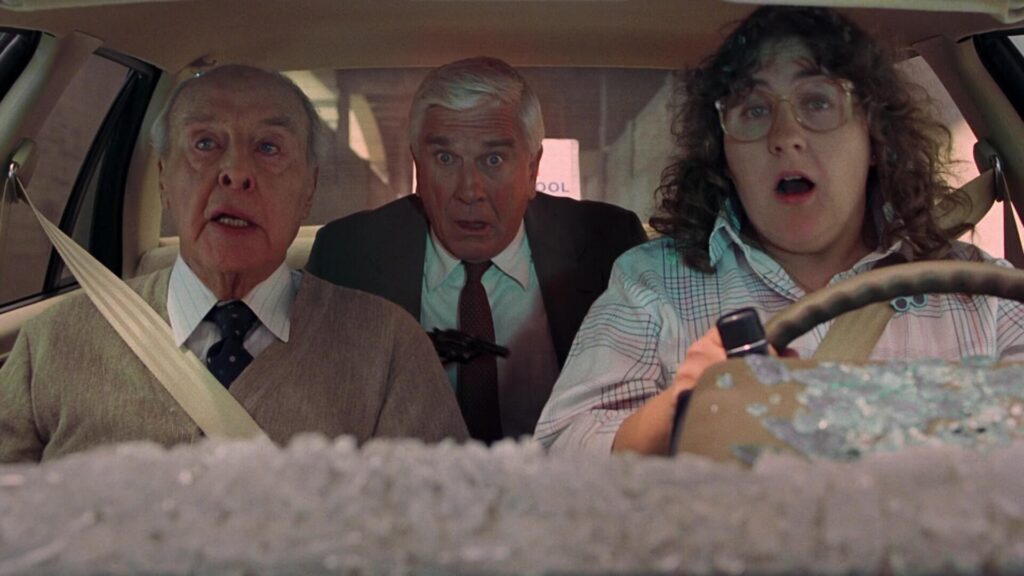 Leslie Nielsen, George Kennedy, & Priscilla Presley in The Naked Gun: From the Files of Police Squad! (1988)