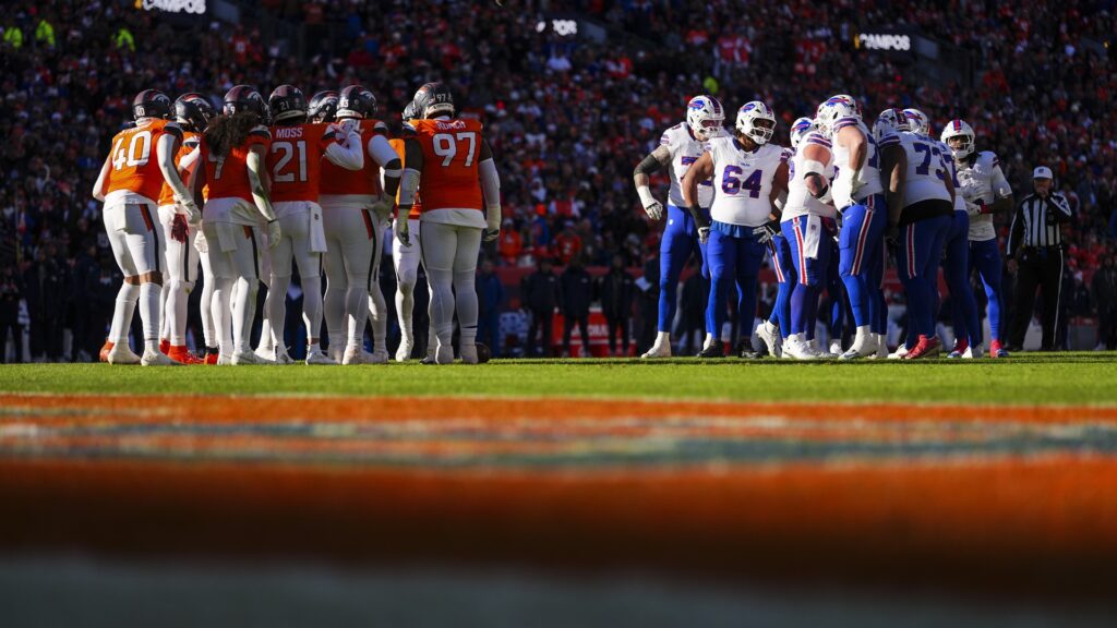 The Denver Broncos and Buffalo Bills huddle during an NFL divisional playoff football game at Empower Field At Mile High on January 17, 2026 in Denver, Colorado.