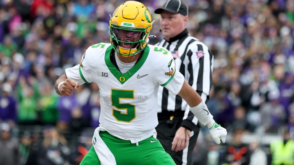 Dante Moore #5 of the Oregon Ducks celebrates his touchdown during the first half against the Washington Huskies at Husky Stadium on November 29, 2025 in Seattle, Washington.