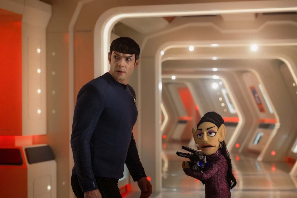 Spock (Ethan Peck) and the puppet version of T’Pring (Gia Sandhu) proceed with caution down a corridor in Season 4, Episode 5 of Star Trek: Strange New Worlds.